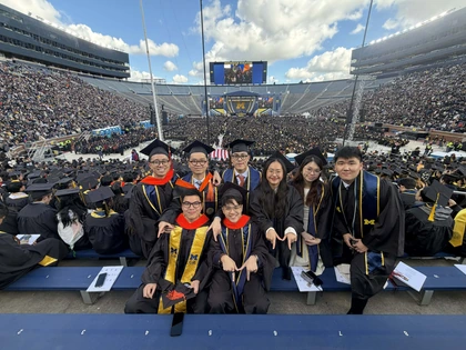 Bao Vo with fellow graduates in Michigan Stadium during University of Michigan commencement, 2026.