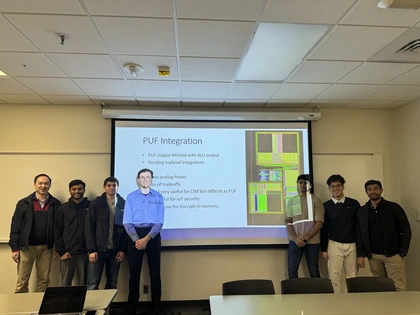 Bao Vo and teammates standing in front of a presentation on PUF integration.